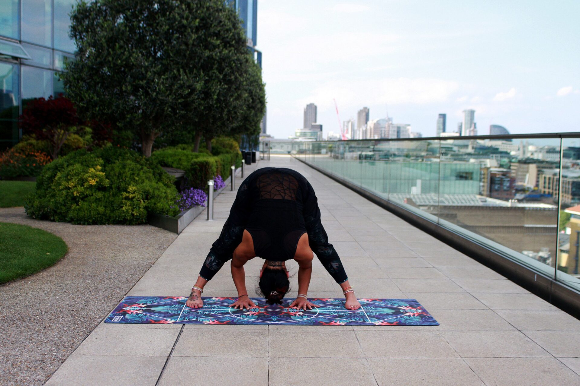 woman doing yoga on city rooftop