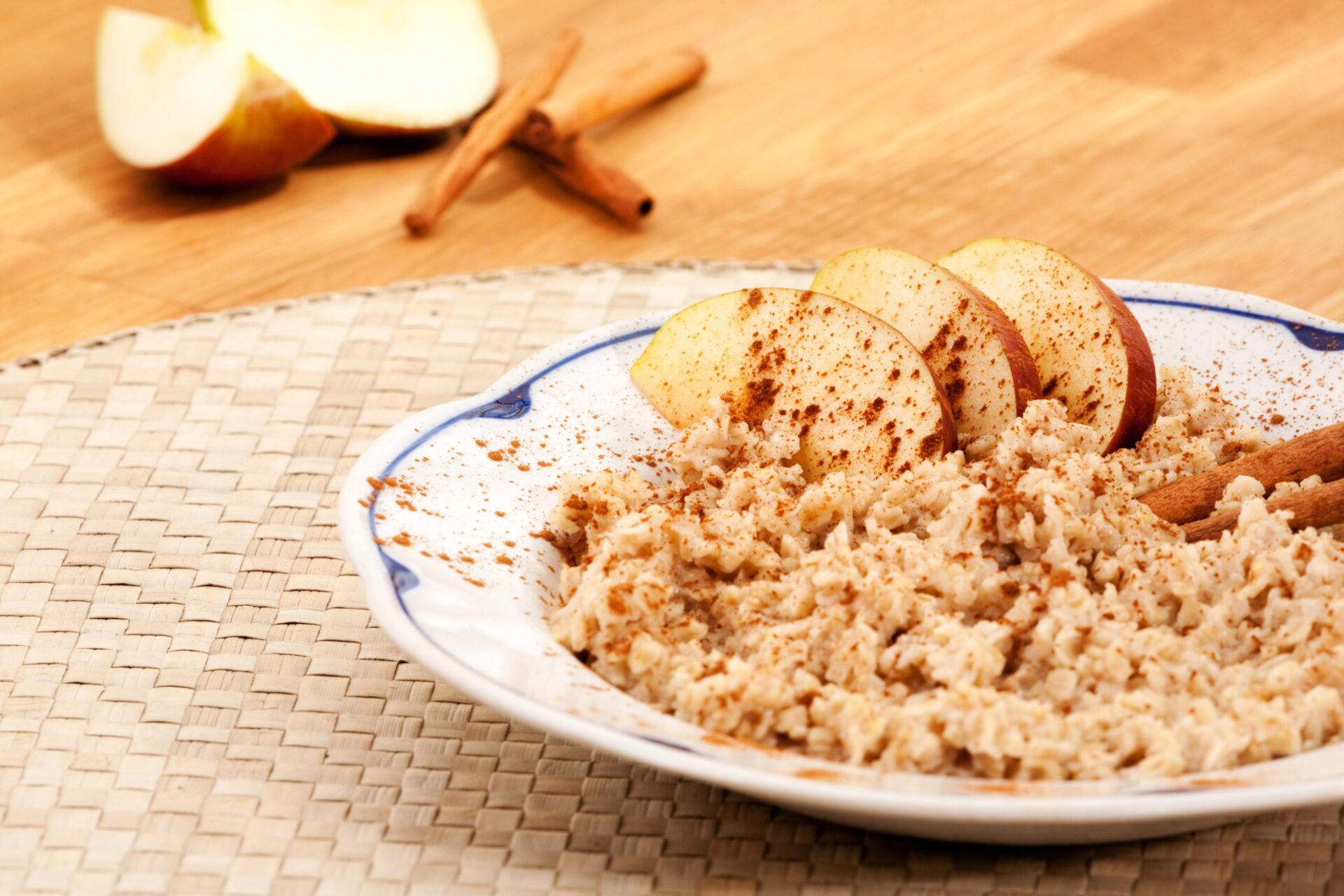 bowl of oatmeal topped with cinnamon and apple slices