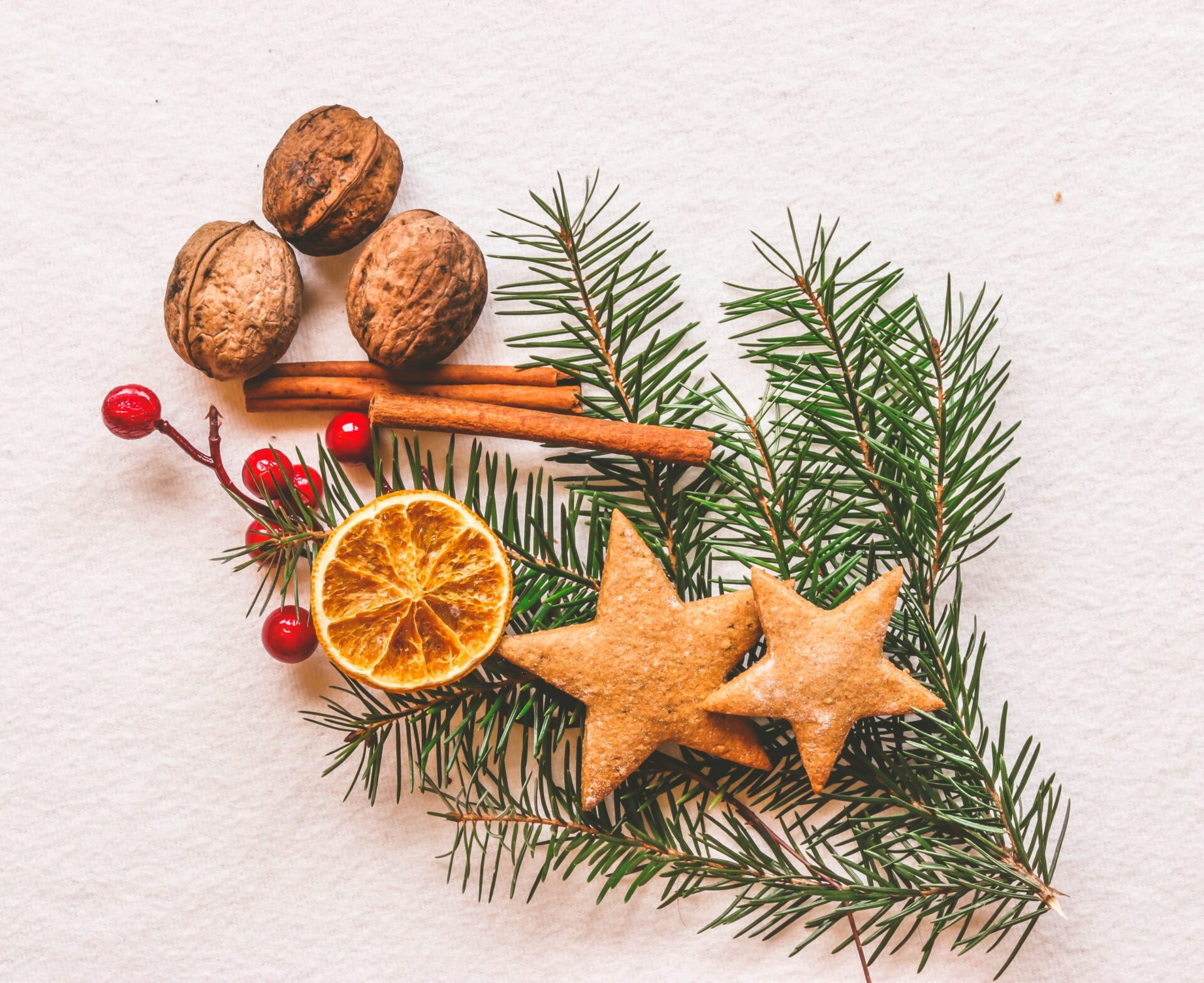 rosemary sprig with christmas cookies, walnuts, cinnamon stick and cranberries