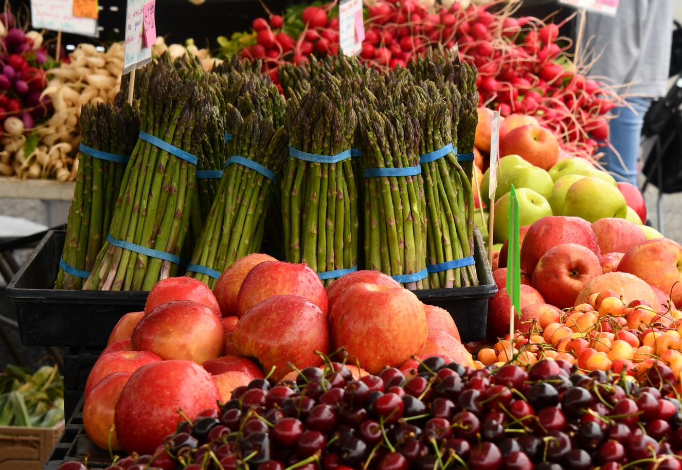 asparagus, peaches, cherries, apples and turnips at a farmer's market